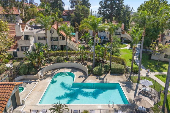 Outdoor swimming pool area with adjacent residential buildings.