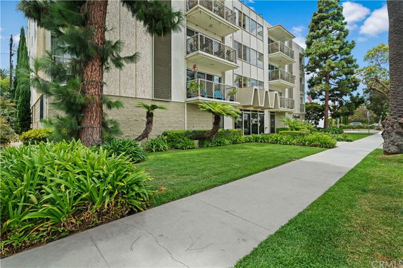 Front view of a multi-story apartment building with balconies.