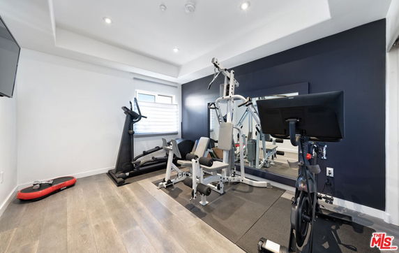Indoor gym area with exercise equipment.