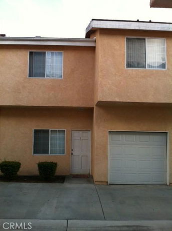 Front view of a two-story house with a garage.