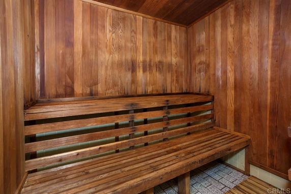 Interior view of a wooden sauna room with benches.