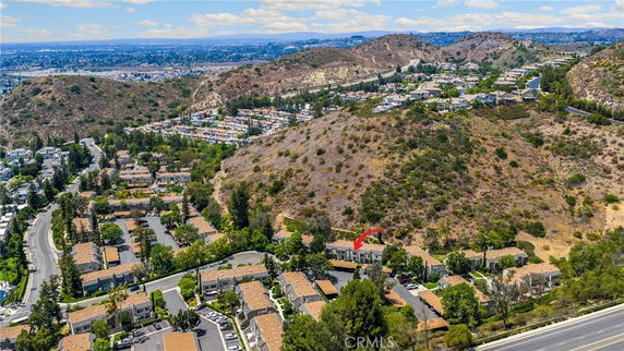 Panoramic view of residential area with surrounding hills.