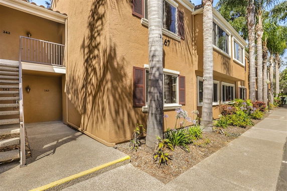 Front view of a two-story apartment building with external staircase.