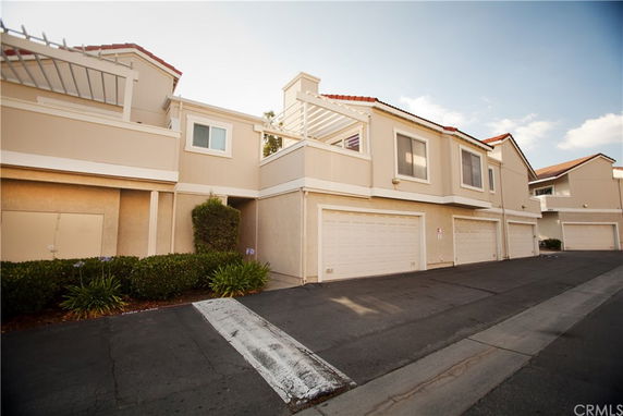 Front view of a townhouse with attached garages.