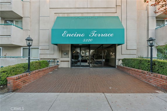 Entrance view of a building with green awning labeled 'Encino Terrace'.