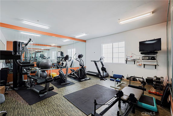 Indoor gym area with various exercise equipment including treadmills, a weight bench, and an exercise bike.