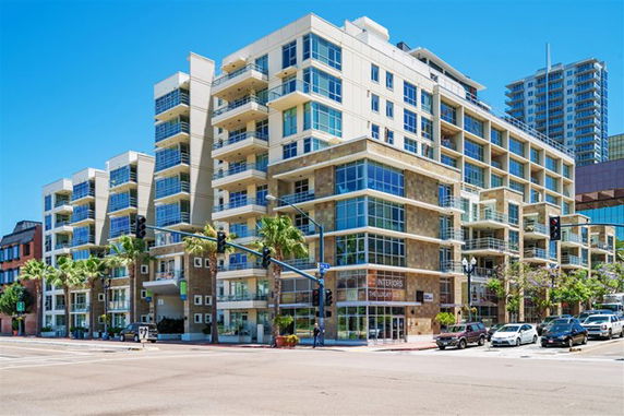 Front view of a multi-story apartment building with balconies.
