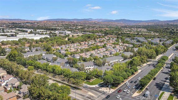 Aerial view of a residential neighborhood with multiple houses and surrounding roads.