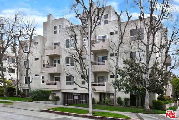 Front view of a multi-story residential building with balconies.