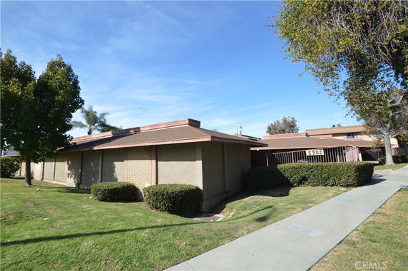 Front view of a single-story building with a flat roof and brick exterior.