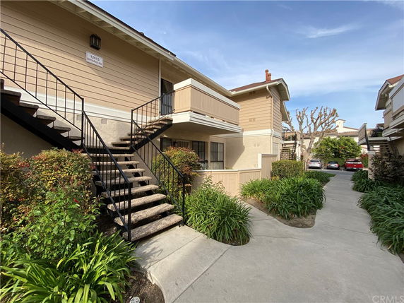 Front view of a two-story building with an external staircase.