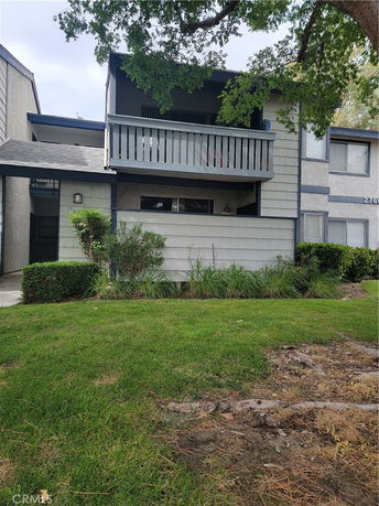 Front view of a two-story residential building with balcony.