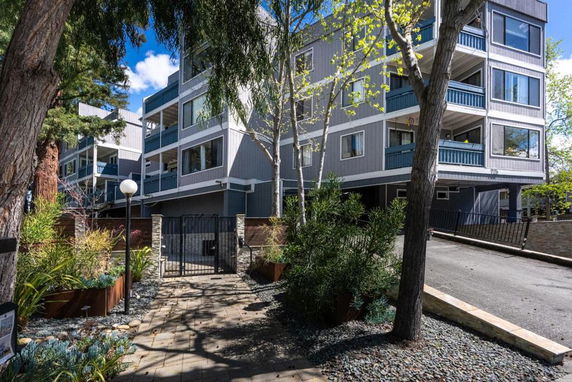 Front view of a multi-story residential building with balconies.