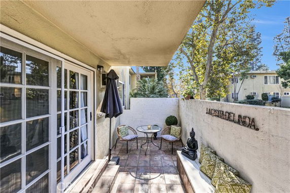 Outdoor patio area with seating and decorative elements.