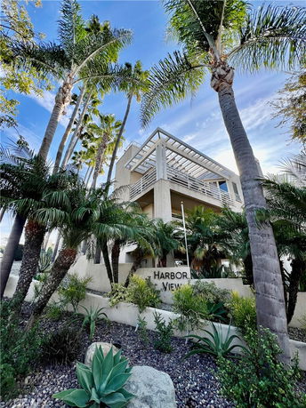 Front view of a multi-story building with a modern design and large windows.