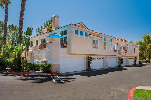 Front view of a multi-story residential building with garages.