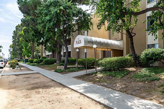 Front view of a multi-story building with entrance canopy.