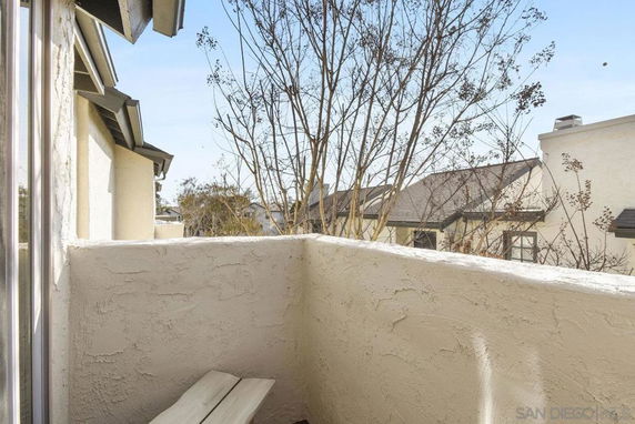 View from a balcony or terrace showing nearby residential buildings.