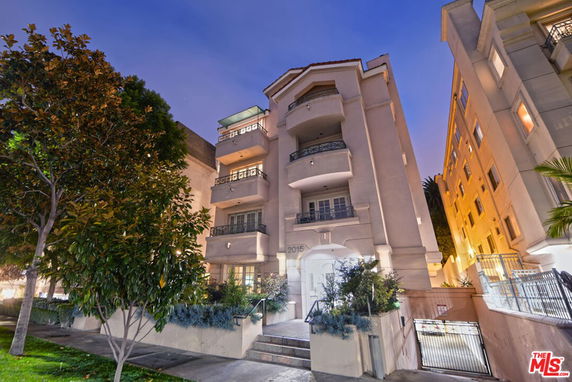 Front view of a multi-story residential building with balconies.