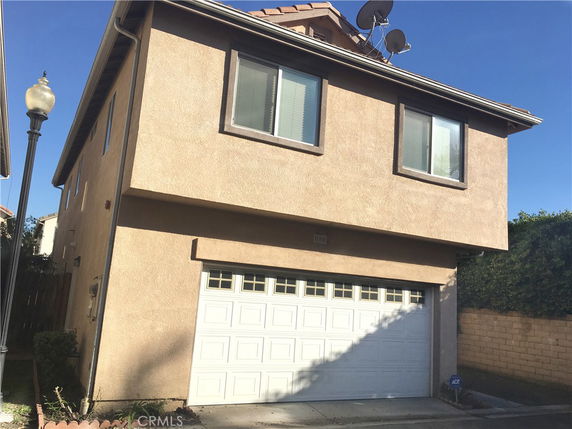 Front view of a two-story house with a garage.