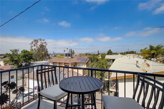 Rooftop view with solar panels and outdoor seating.
