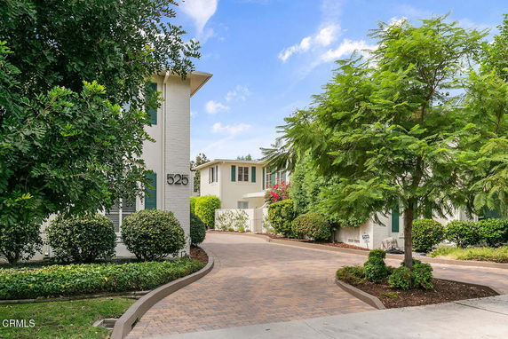 Front view of a two-story house with a paved driveway.