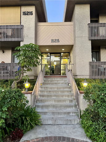 Front view of a building with concrete stairs leading to the entrance.