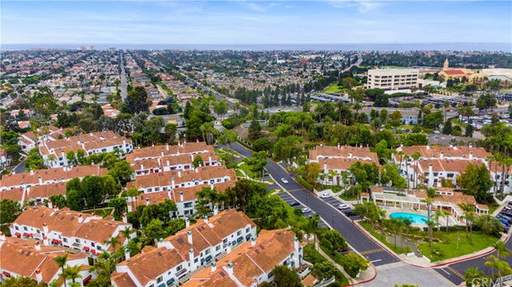Wide-angle view of residential area with multiple multi-story buildings and roads.