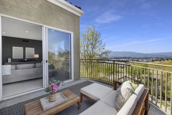 Balcony view overlooking a scenic landscape and valley.