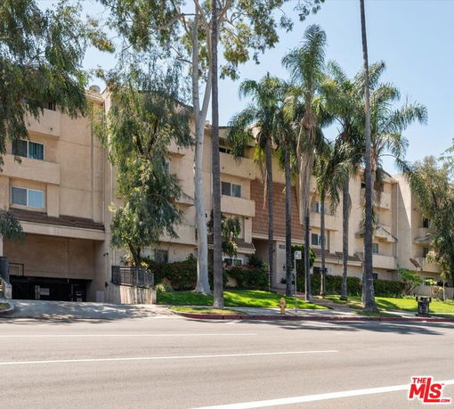 Front view of a multi-story residential building with balconies.