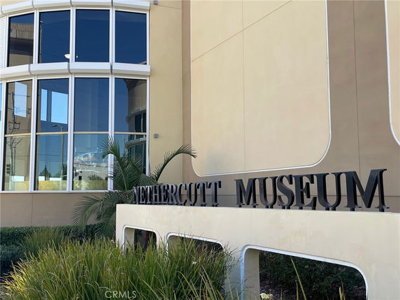 Front view of a museum building with large windows.