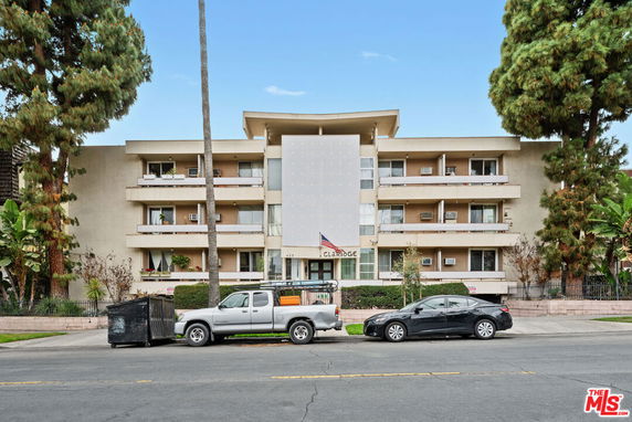 Front view of a multi-story apartment building with balconies.