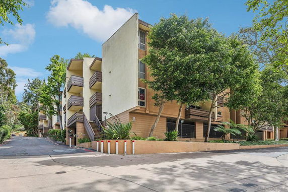 Front view of a multi-story apartment building with balconies.