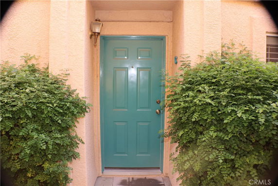 Front view of a house entrance with green door.