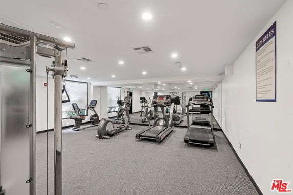 Indoor gym area with exercise equipment and treadmills.