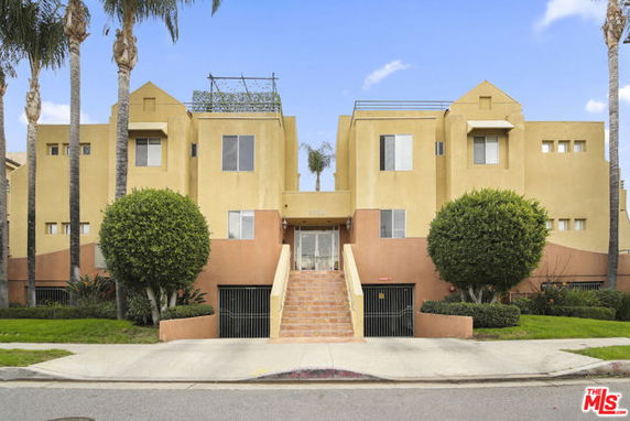 Front view of a multi-story building with a central staircase.