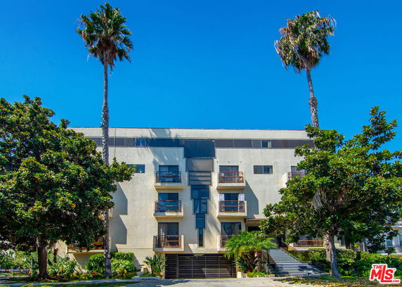 Front view of a multi-story building with balconies.
