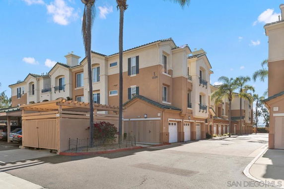 Front view of a multi-story residential complex with garages.