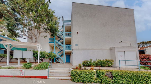 Front view of a multi-story building with external staircases.