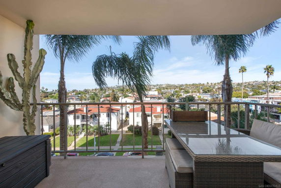 Panoramic view from a balcony overlooking residential area.