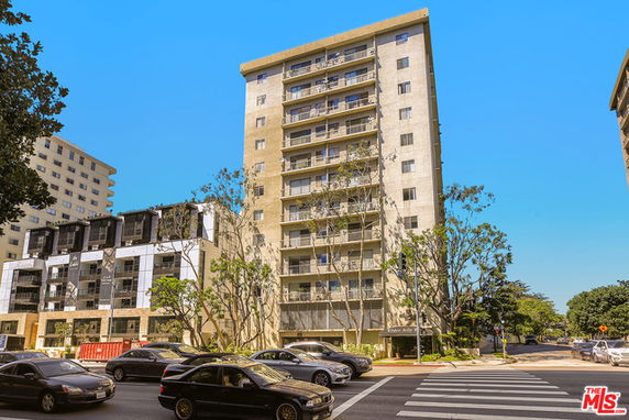 Front view of a multi-story residential building with balconies.