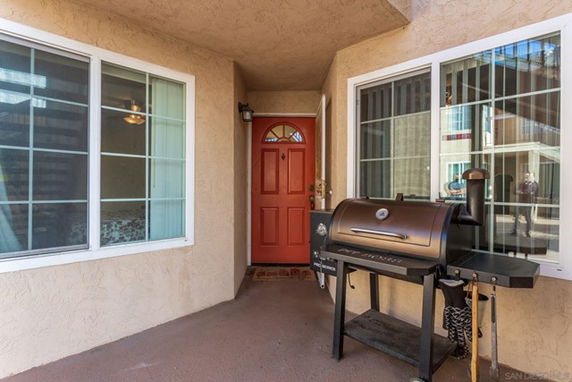 Front view of a house entrance with a red door.