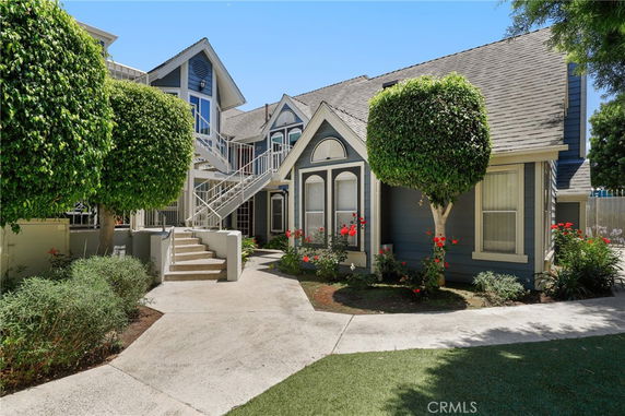 Front view of a two-story residential building with a staircase leading to the upper level.