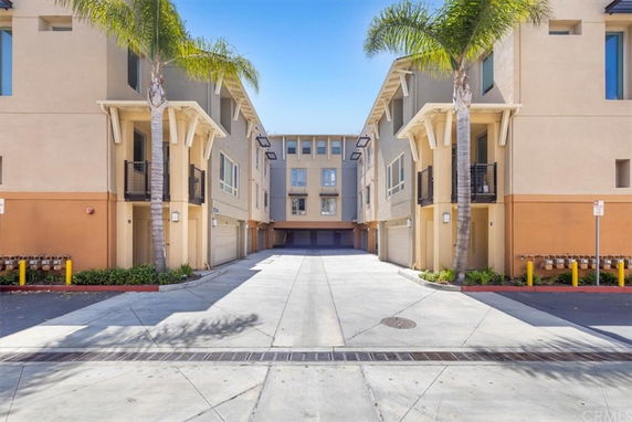 Front view of a multi-story apartment building with balconies.
