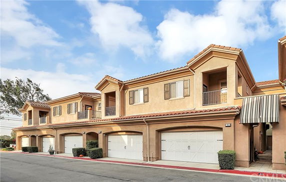 Front view of a two-story building with multiple garages.