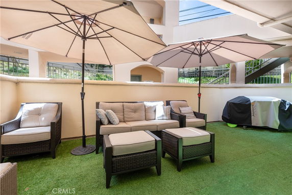 Patio area with outdoor furniture under umbrellas.