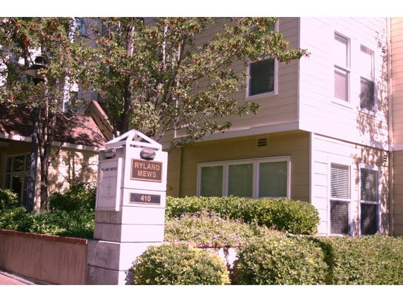 Front view of a multi-story residential building with a sign reading 'Ryland Mews 410'.