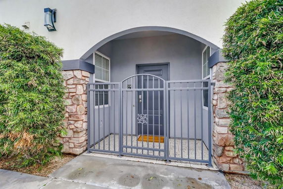 Front view of a house entrance with a gated archway.
