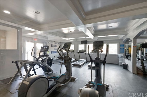 Indoor gym area with exercise equipment and natural lighting.
