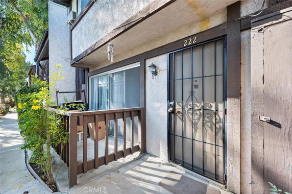 Front view of a residential building entrance with a metal security door.